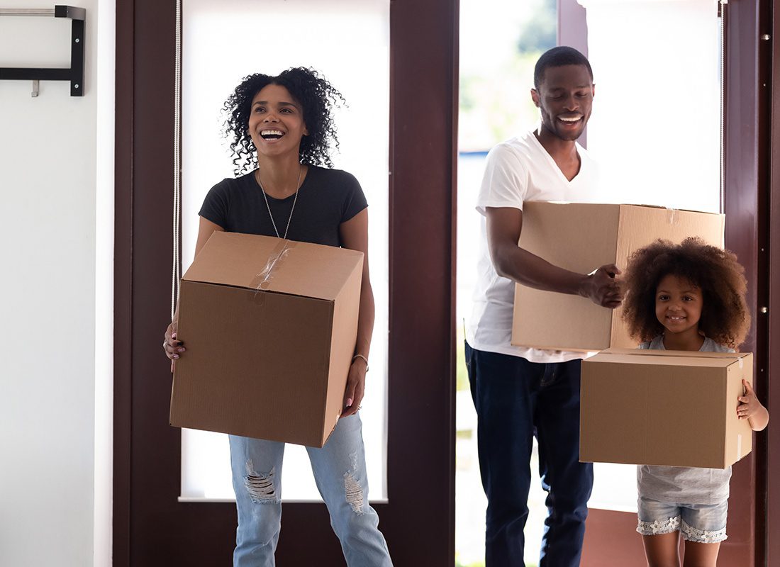 Personal Insurance - Happy Family and Their Daughter Carry in Boxes into Their New Home